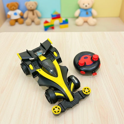 Toy race car with remote control on a wooden surface, with teddy bears in the background.