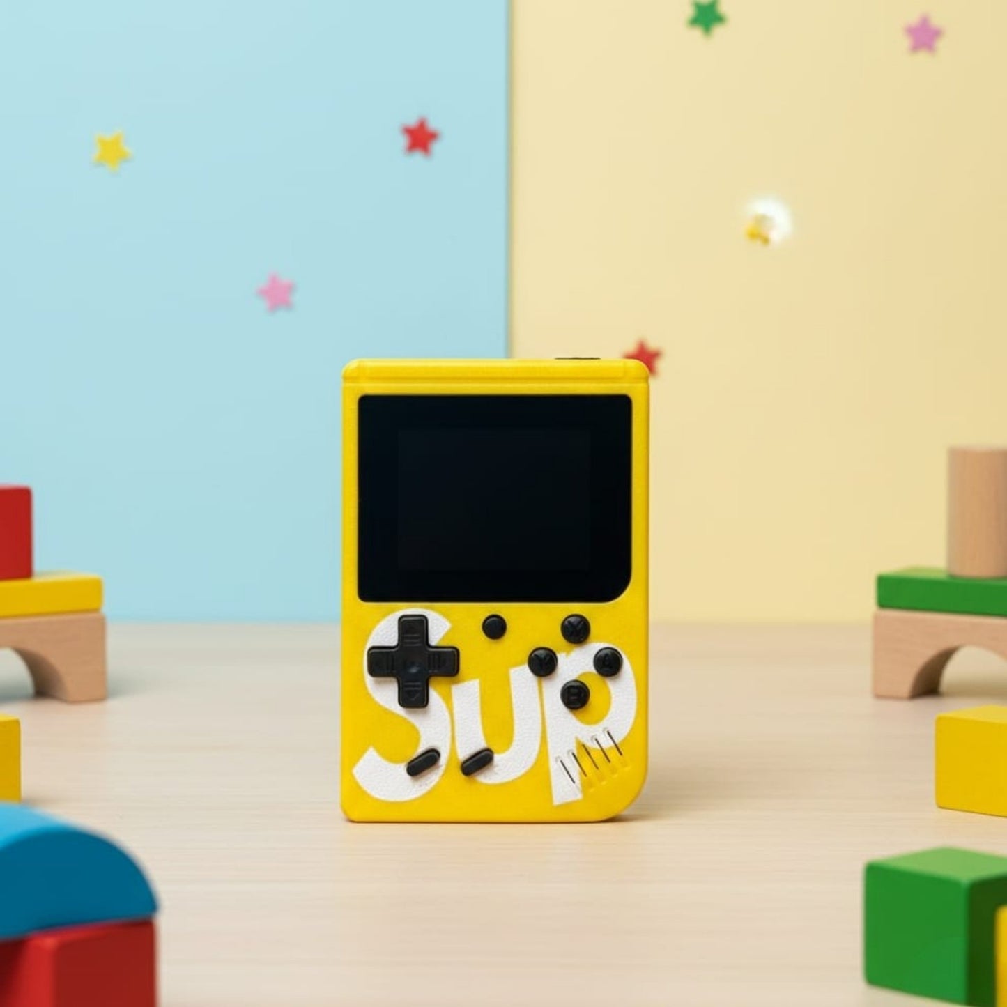 Yellow handheld gaming console with 'SUP' logo on a colorful background -Baby Nest