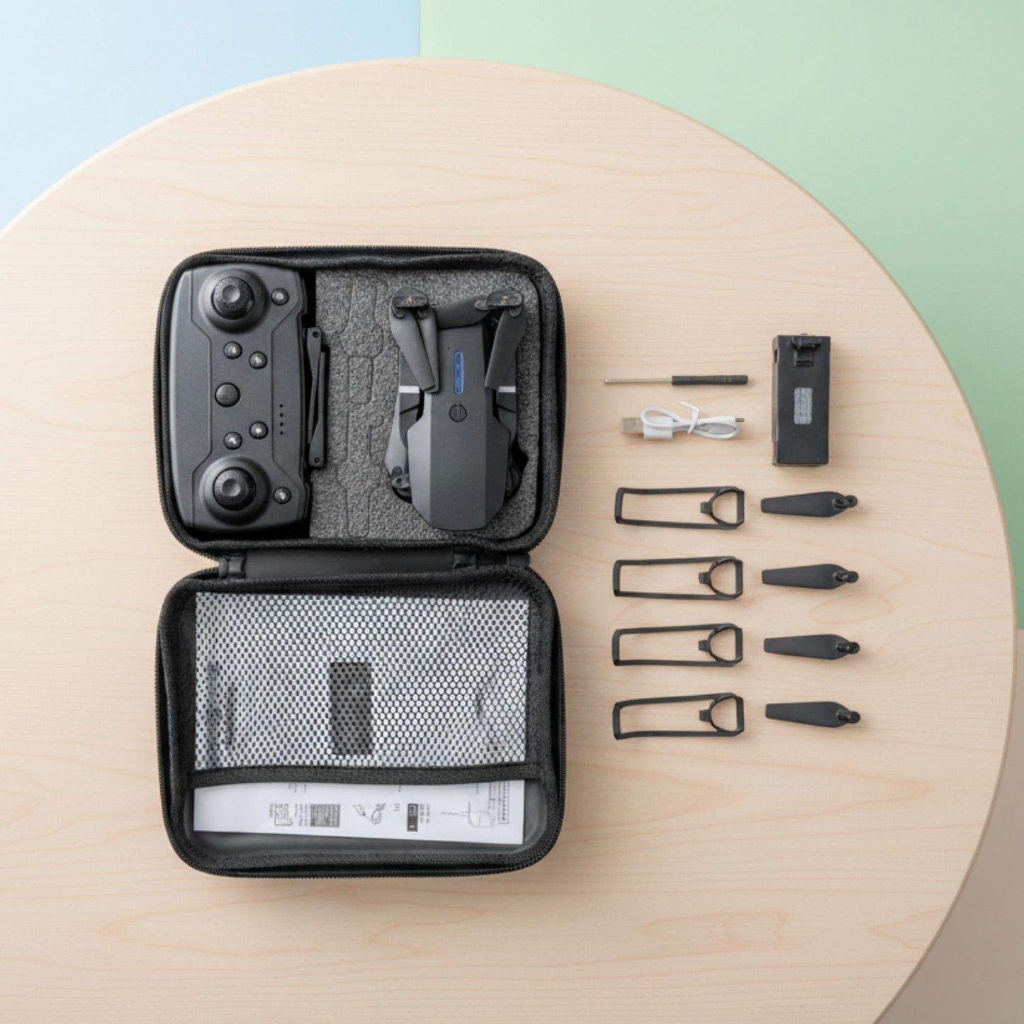 Set of tools and equipment in a black case on a wooden surface with a colorful background