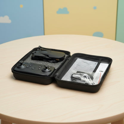 Black travel case with electronic device on a round beige table against a colorful wall.