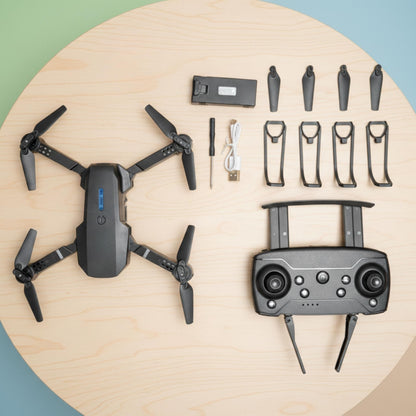 Drone and its components on a wooden surface